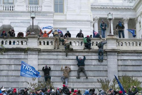 Image: tRump thugs assault Capitol on Jan. 6th. Pic by Jose Luis Magana, AJC...